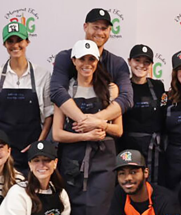 Harry and Meghan’s cuddles over cookies: ‘Protective’ Prince wraps his arms around Duchess to ‘stress their closeness’ at Thanksgiving charity event with Lilibet and Archie after string of PR disasters