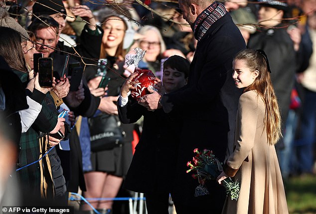 Presents for the Princess and Princes! George, Charlotte and Louis get handfuls of gifts on Christmas Sandringham walkabout