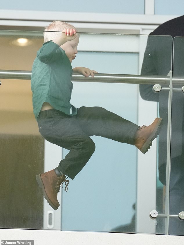 Mike and Zara Tindall’s son Lucas, 4, pulls faces and monkeys around during family day out at Cheltenham